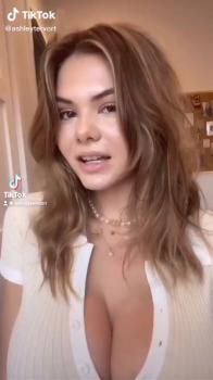 Kitty Lara plays with her big tits in black bra